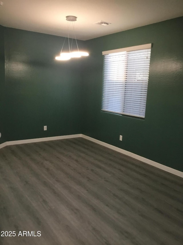 4722 S 238th Ln, Buckeye, AZ 85326 - spare room with dark wood-style flooring and baseboards
