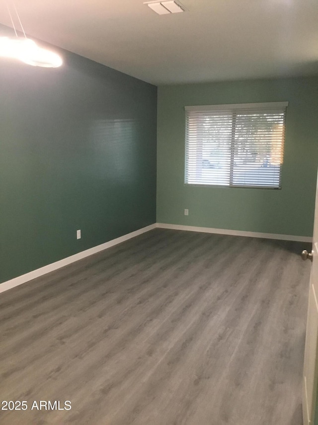 4722 S 238th Ln, Buckeye, AZ 85326 - unfurnished room featuring wood finished floors and baseboards