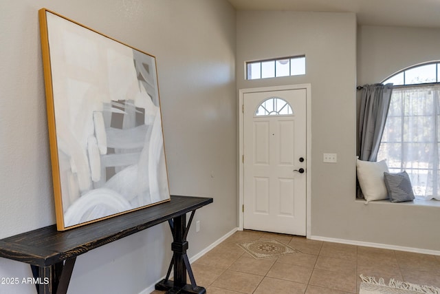 tiled entrance foyer with vaulted ceiling