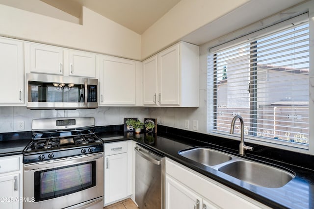 kitchen featuring stainless steel appliances, sink, and white cabinets