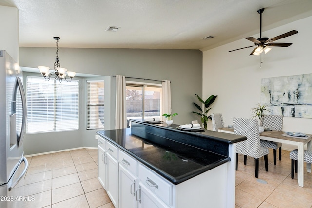 kitchen with white cabinetry, light tile patterned floors, decorative light fixtures, and stainless steel fridge with ice dispenser