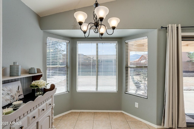 dining room with an inviting chandelier, light tile patterned floors, and vaulted ceiling