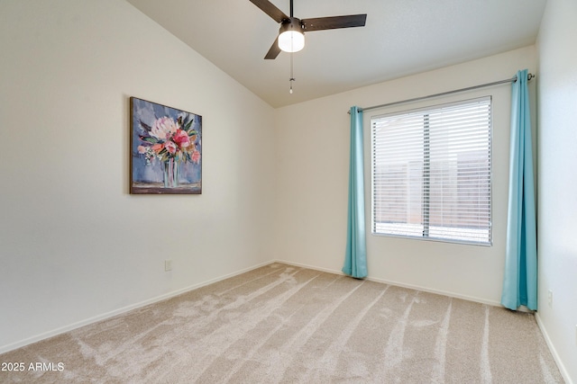 unfurnished room featuring ceiling fan, light colored carpet, and vaulted ceiling