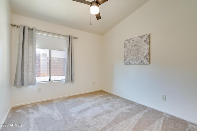 empty room featuring light carpet, vaulted ceiling, and ceiling fan