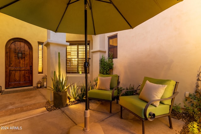 view of exterior entry featuring a patio and stucco siding