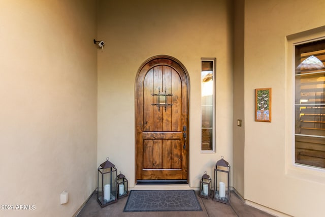 doorway to property featuring stucco siding