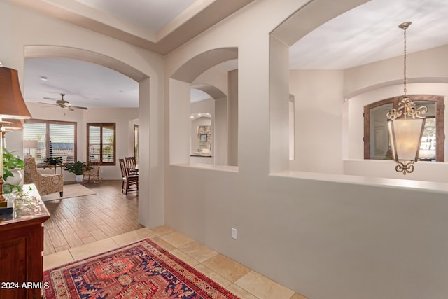 corridor featuring light hardwood / wood-style flooring and a chandelier