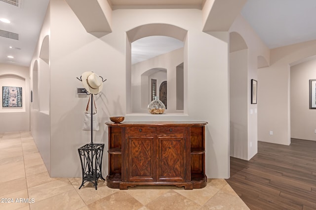 corridor with light wood-type flooring, recessed lighting, and visible vents