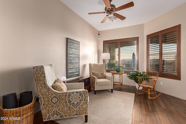 sitting room with vaulted ceiling, hardwood / wood-style floors, and ceiling fan