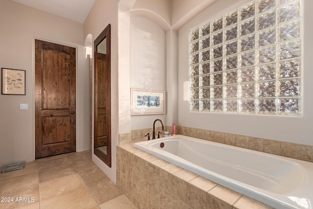 bathroom featuring a stall shower and a garden tub