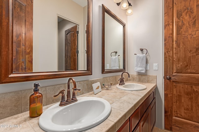 full bath with double vanity and a sink