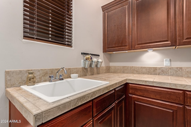 kitchen with tile counters and sink