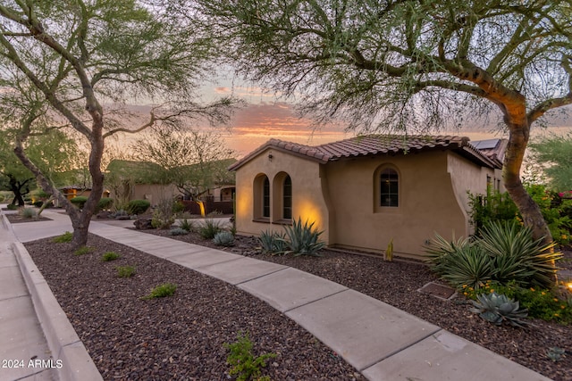 mediterranean / spanish-style home featuring a tiled roof and stucco siding