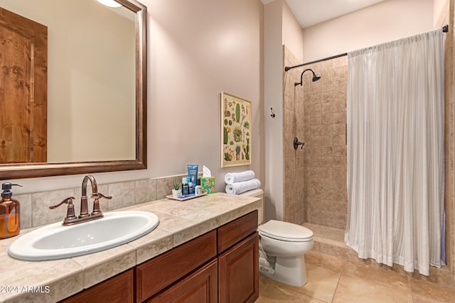 bathroom with toilet, vanity, a shower with shower curtain, and tile patterned flooring