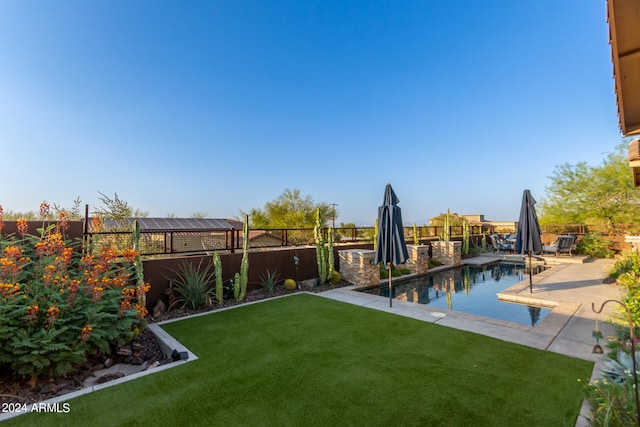 view of yard featuring a fenced in pool and a patio area