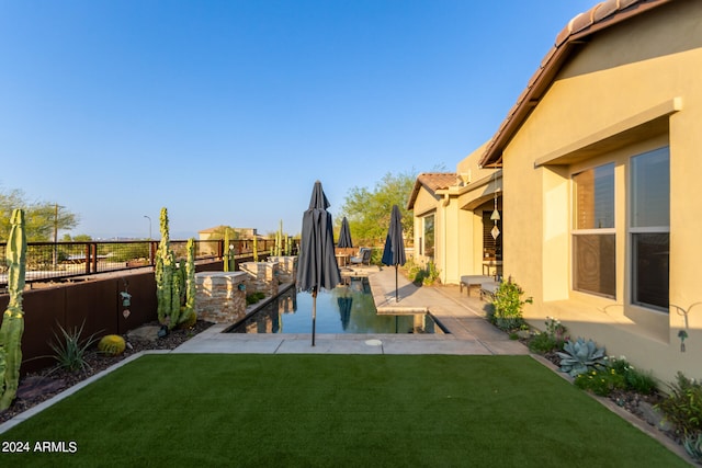 view of yard with a fenced in pool and a patio area