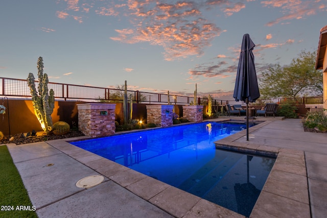 view of swimming pool with a patio area, fence, and a fenced in pool