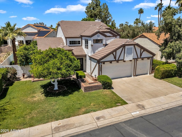 tudor-style house featuring a garage, driveway, a tile roof, and a front yard