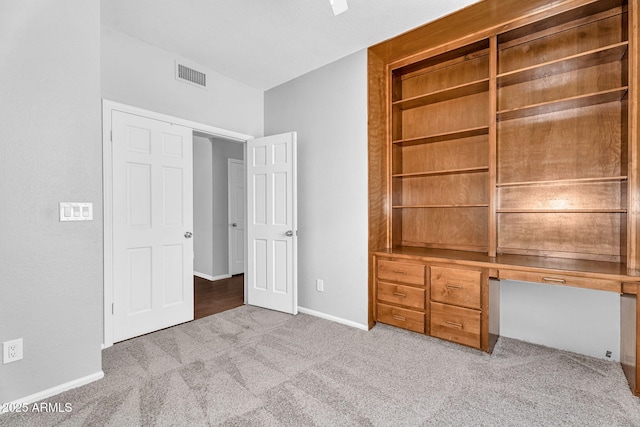 unfurnished bedroom featuring visible vents, carpet flooring, and baseboards
