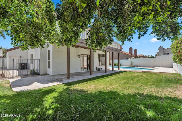 back of property with a yard, a fenced backyard, and stucco siding