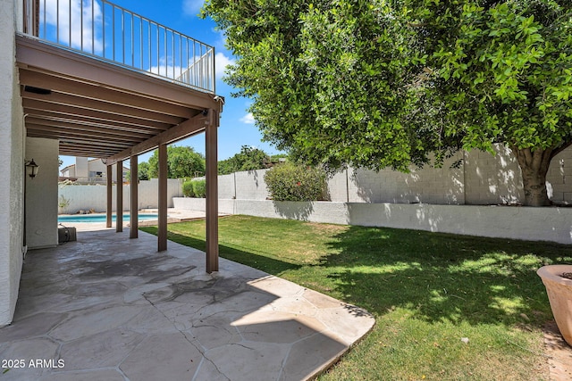 view of yard with a fenced in pool, a fenced backyard, a patio area, and a balcony