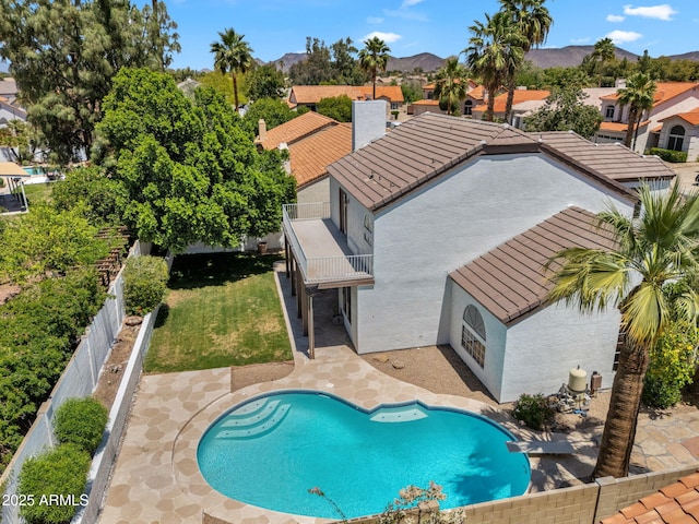 view of pool featuring a fenced backyard, a fenced in pool, a patio area, a mountain view, and a yard