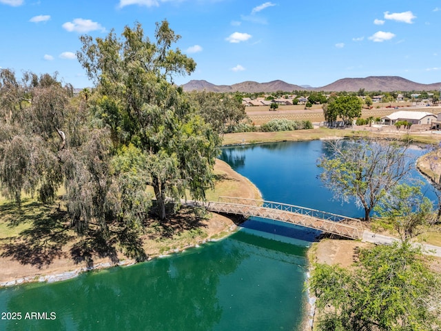 birds eye view of property featuring a water and mountain view