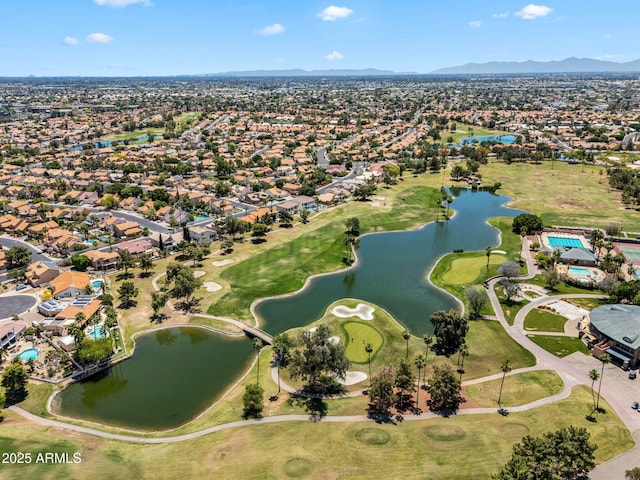 drone / aerial view with a residential view, golf course view, and a water and mountain view