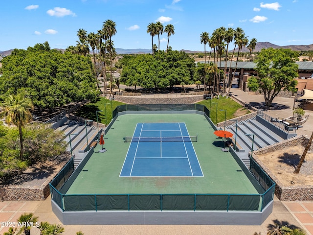 view of sport court with fence and a mountain view
