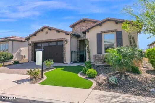 mediterranean / spanish home with stucco siding, driveway, and an attached garage