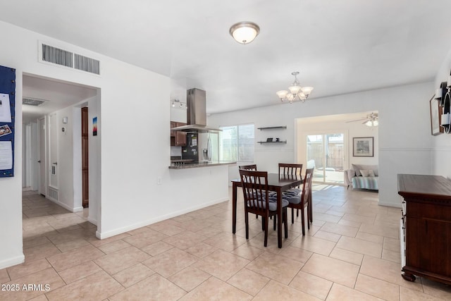 dining space featuring ceiling fan with notable chandelier