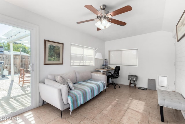 office space with vaulted ceiling, light tile patterned flooring, and ceiling fan