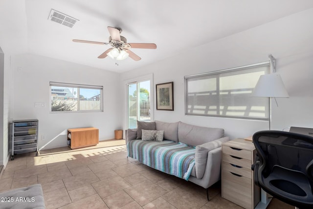 tiled living room with ceiling fan