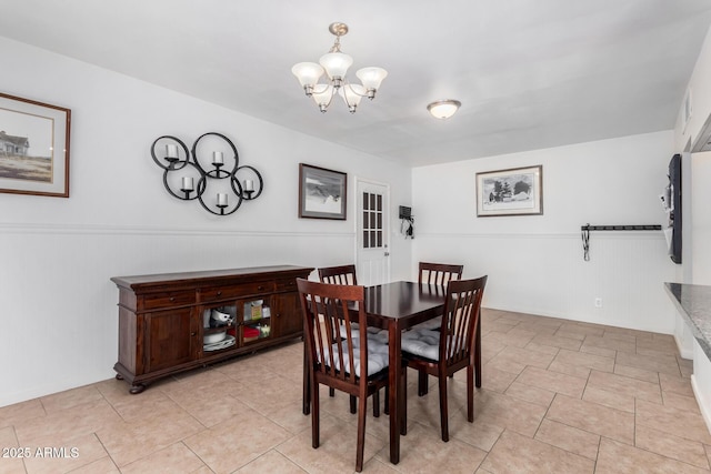 dining area featuring light tile patterned floors and a chandelier