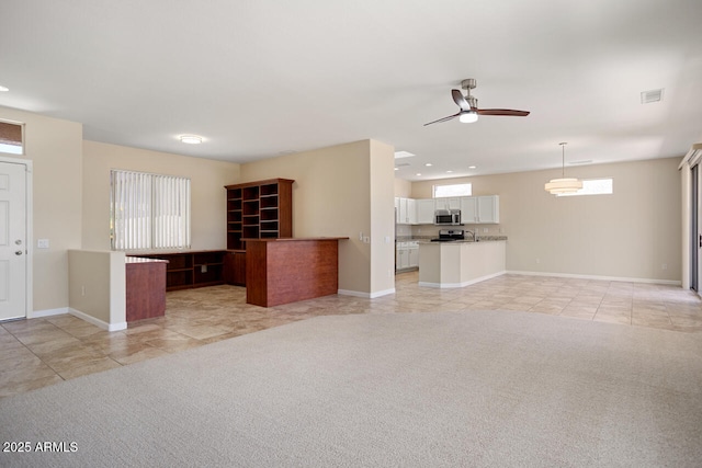 20007 N Siesta Rock Dr, Surprise, AZ 85374 - unfurnished living room with light tile patterned floors, ceiling fan, baseboards, and recessed lighting