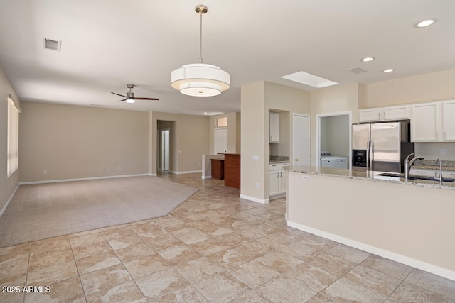 20007 N Siesta Rock Dr, Surprise, AZ 85374 - kitchen with stainless steel fridge with ice dispenser, a sink, white cabinets, light stone countertops, and ceiling fan