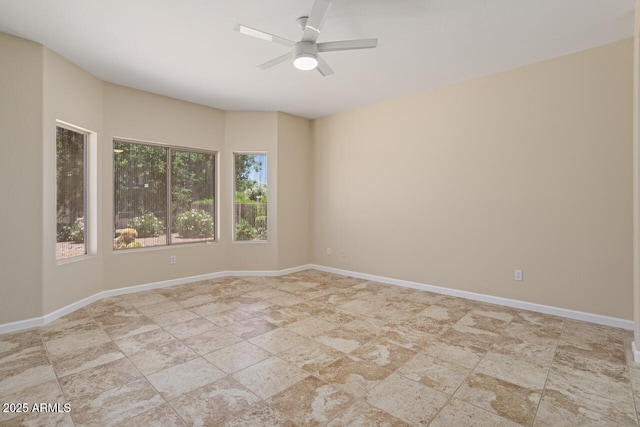 20007 N Siesta Rock Dr, Surprise, AZ 85374 - unfurnished room with a ceiling fan, light stone finish floors, and baseboards
