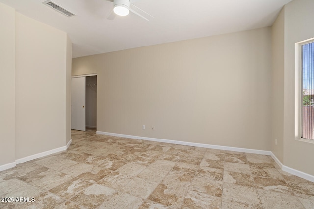 20007 N Siesta Rock Dr, Surprise, AZ 85374 - empty room featuring ceiling fan, stone finish flooring, and baseboards