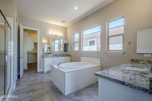 bathroom featuring separate shower and tub, tile patterned floors, and vanity