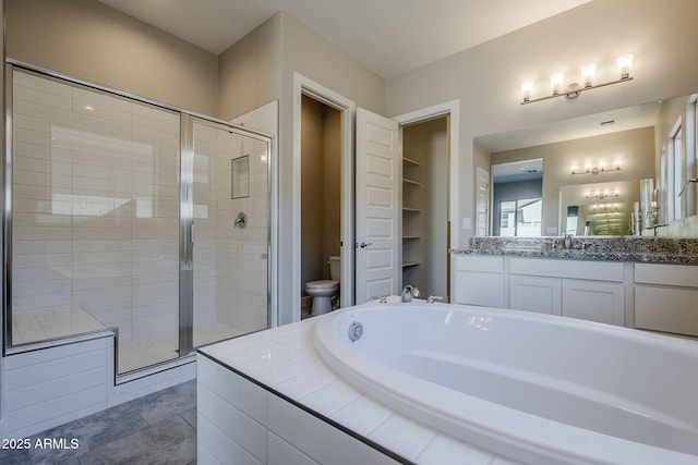 full bathroom featuring toilet, shower with separate bathtub, and vanity