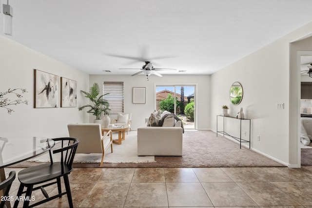 973 E Kelsi Ave, San Tan Valley, AZ 85140 - carpeted living area with a ceiling fan, baseboards, and tile patterned flooring