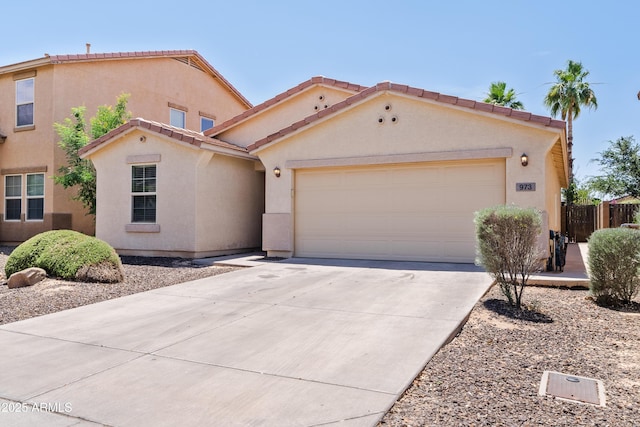 973 E Kelsi Ave, San Tan Valley, AZ 85140 - mediterranean / spanish-style home with an attached garage, driveway, stucco siding, and a tiled roof