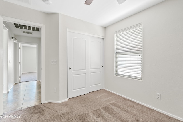 973 E Kelsi Ave, San Tan Valley, AZ 85140 - unfurnished bedroom with light colored carpet, a closet, baseboards, and a ceiling fan