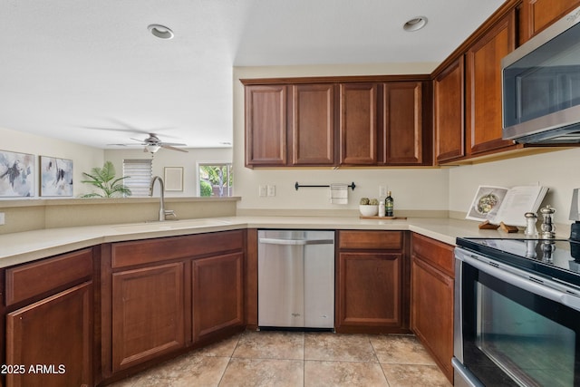 973 E Kelsi Ave, San Tan Valley, AZ 85140 - kitchen with stainless steel appliances, a sink, light countertops, ceiling fan, and light tile patterned floors