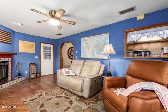 living room with ceiling fan and parquet flooring