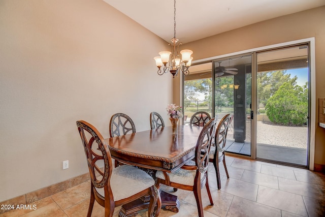 tiled dining area featuring ceiling fan with notable chandelier and vaulted ceiling