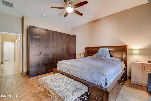 bedroom with ceiling fan, a closet, and light hardwood / wood-style floors