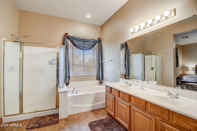 bathroom featuring plus walk in shower, hardwood / wood-style floors, and vanity