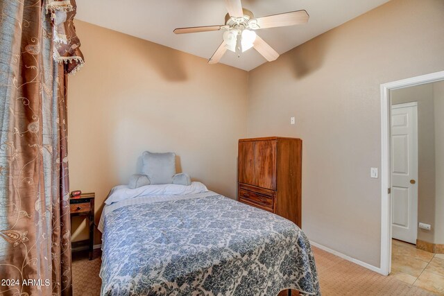 bedroom with light carpet and ceiling fan