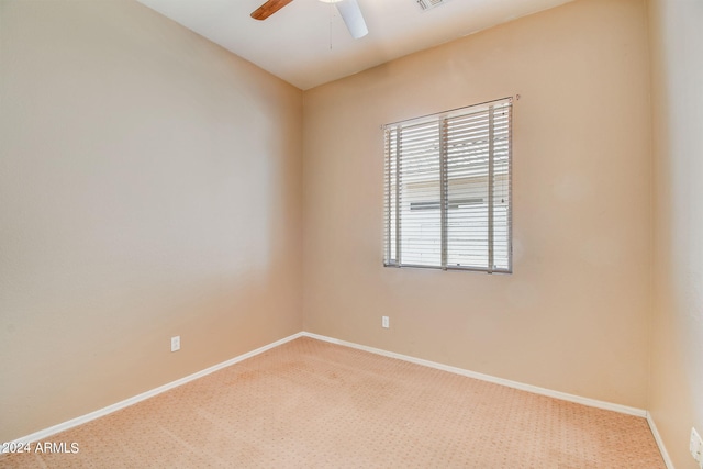 carpeted empty room featuring ceiling fan